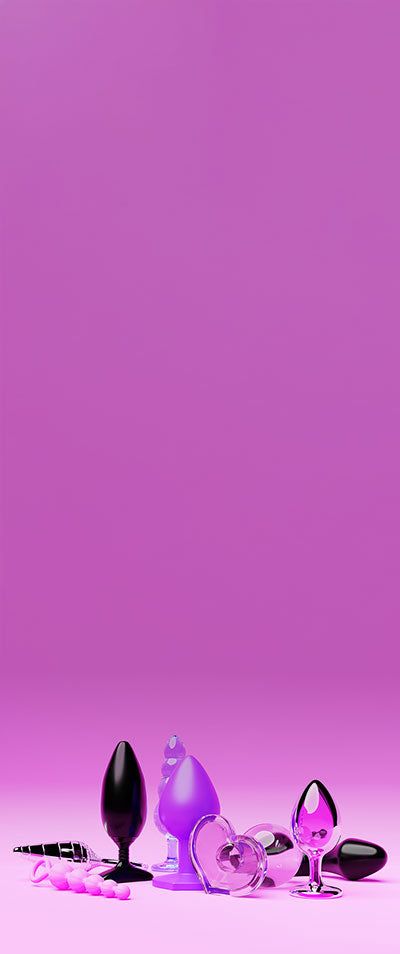 Assorted silicone butt plugs on a pink background