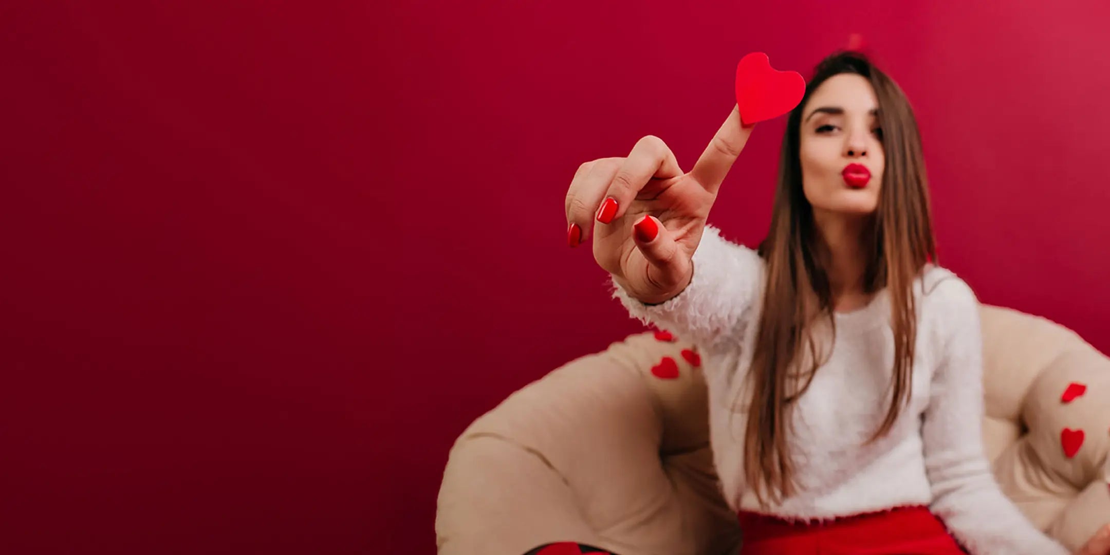 Elegant girl holding a confetti heart